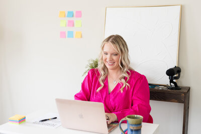 Becca smiling as she chats on a video call with a consulting client