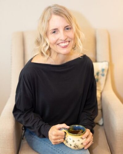 Lisa Tomsio holistic nutritionist health coach  with cup of tea welcoming sustainable habit change