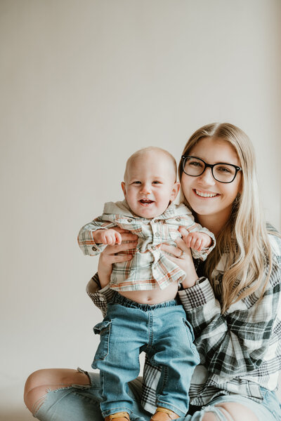 Mom with son with neutral background in flannels
