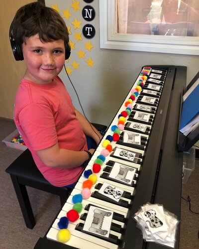 Child learning to play the piano in Edmond Oklahoma