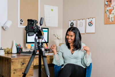 Alexis Campbell speaking in front of a camera