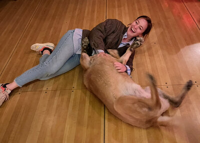 Girl with sunglasses scratches her horse's head lovingly