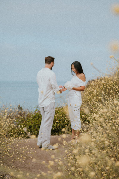 a couple exchanging their vows on the beach of malibu california with their elopement photographer