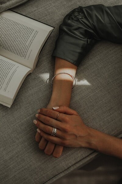 kaboompics_hands-silver-jewelry-bracelet-rings-book-32272resize