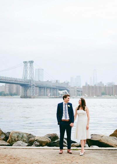 35mm film photo of a couple by the bridge in Brooklyn, during their wedding at Aurora