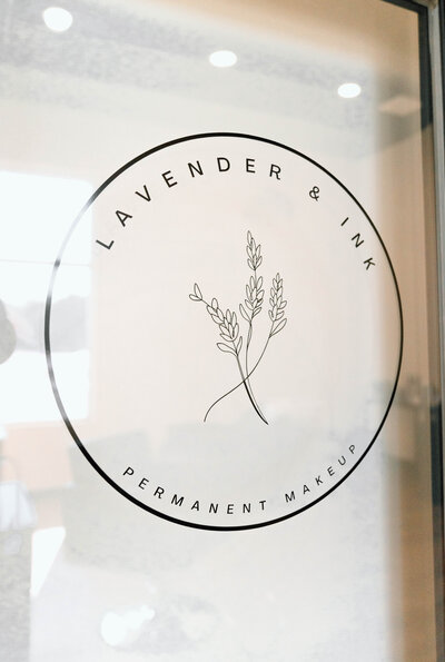 Lavender & Ink Studios permanent makeup logo displayed on glass door.