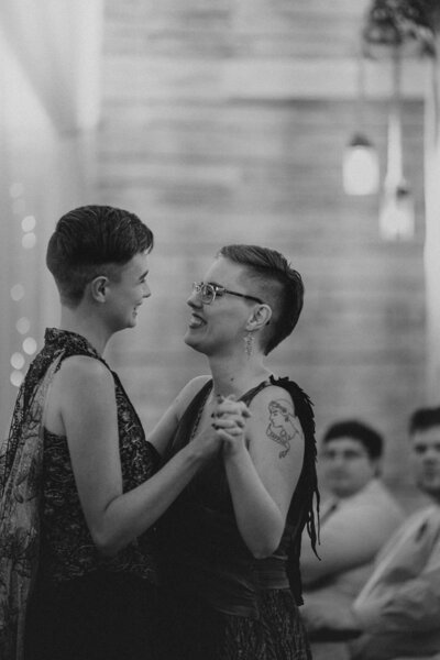 Two people dance at the reception of their LGBTQ wedding