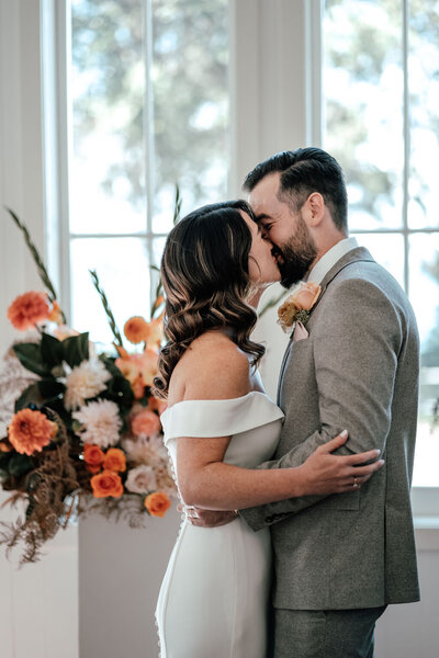 Bride and groom Lorna and Will sharing first kiss inside Man O’ War chapel, Waiheke Island, photographed by Zanthe Vorsatz.