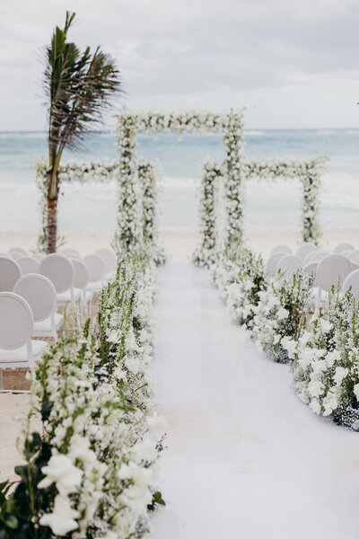 Panamera wedding aisle with all white flowers and three wedding arches