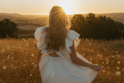 girl sitting in wildflower field