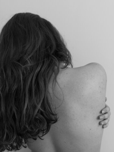 Black and white photo of a woman 's back and hair