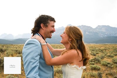 A bride and groom look at each other with mountains in the background, representing the wedding planning service of Four Eyes Events