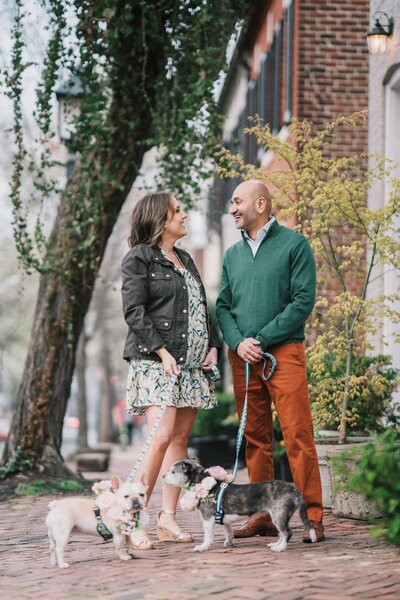 Georgetown Virginia Engagement photo couple talking on the street with two pets