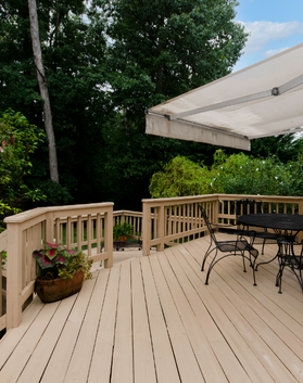 Wooden deck installed with outdoor seating area by Black Bear Roofing & Exteriors.