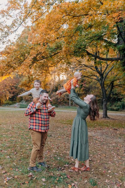 Fall Family Photos with Asheville Motherhood Photographer photographs mom, dad and baby in the fall colors in Hendersonville, NC