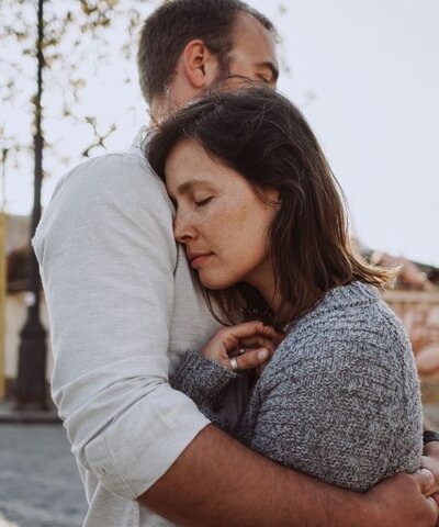 A couple hug in the street. Their hug could symbolize newfound trust between the two after an affair recovery program. We can support you with affair counseling in Florida and other services. Contact an affair recovery therapist for support in recovering from infidelity