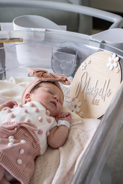 newborn baby with name plate in hospital by las vegas birth photographer