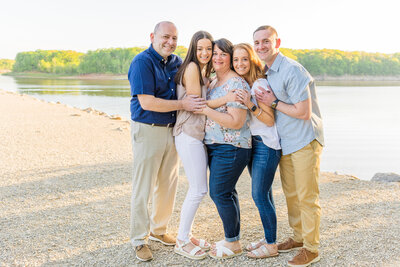 couple hugging their teenage daughters