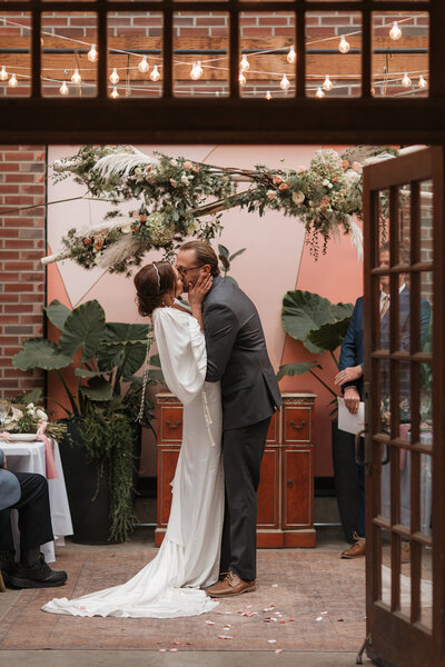 Bride and groom kissing after saying "I do" at Verde on Cherokee by St. Louis photographer, Jacoby Andrick