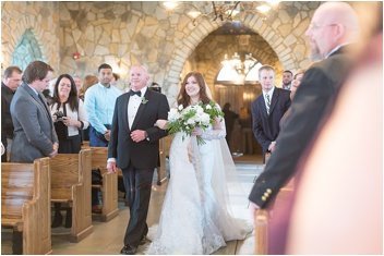 bride walking down the aisle inside cliffs at glassy chapel