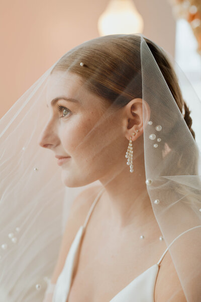 profile of bride in veil beaded with pearls 