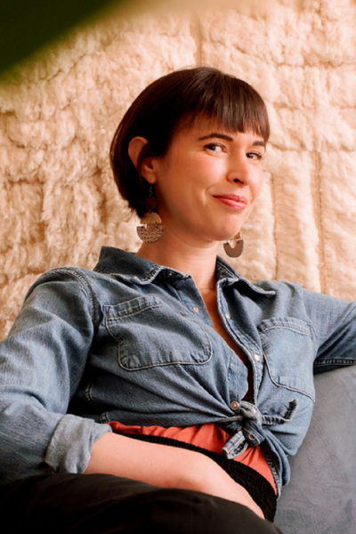 Sybil Ottenstein, somatic therapist and clinical director, seated in a cozy Brooklyn therapy office, offering body-based psychotherapy in NYC.