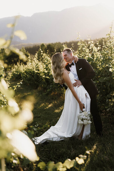 Bride and groom looking into each others eyes at wedding ceremony with guests