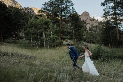 Bride and groom hike during Rocky Mountain National Park adventure elopement.