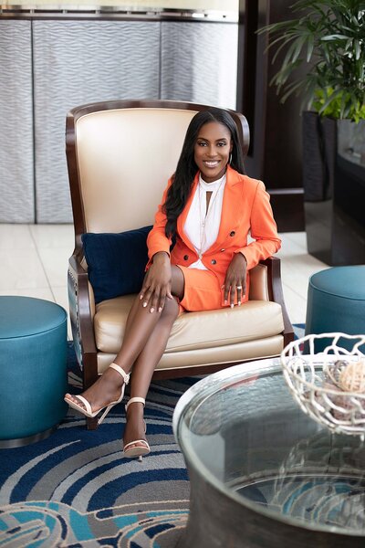 branding photo of fashionable Black woman in business attire sitting in a chair