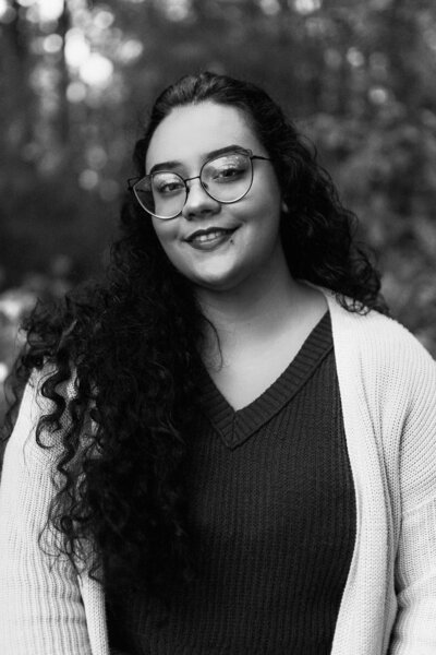woman with glasses smiles