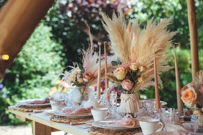 Luxury tea set up with pampas grass and floral decoration along with some tall candles