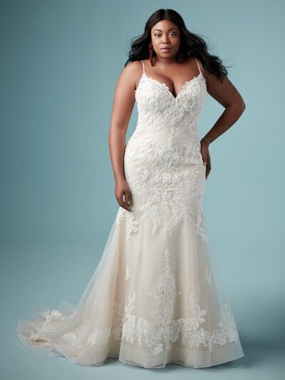 Plus Size Fit-and-Flare Wedding Dress Favorite This lovely fit-and-flare wedding dress offers additional coverage to our Glorietta style. Delicate lace motifs accented with beading are featured throughout this gorgeous tulle gown. Detailed with a sweetheart neckline, beaded spaghetti straps, and an illusion back. Finished with covered buttons over zipper and inner elastic closure.