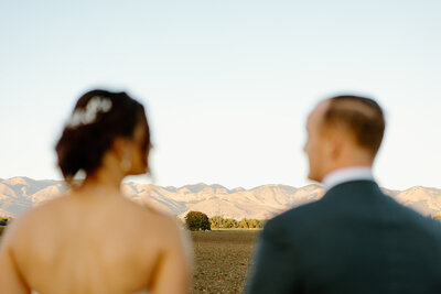 couple sitting on a blanket in the grass