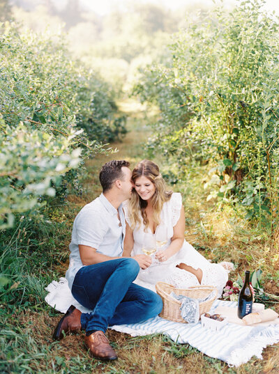 couple holding hands with feet in river water