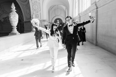 Couples walking down the pathway at San Francisco City Hall