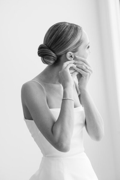 Bride getting ready adjusting earring