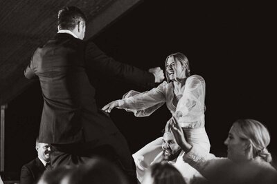 Candid photo of bride and groom dancing at wedding reception