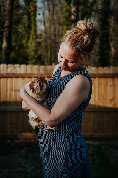 Kelly Loss holds her pet chicken in her yard in Northern Virginia