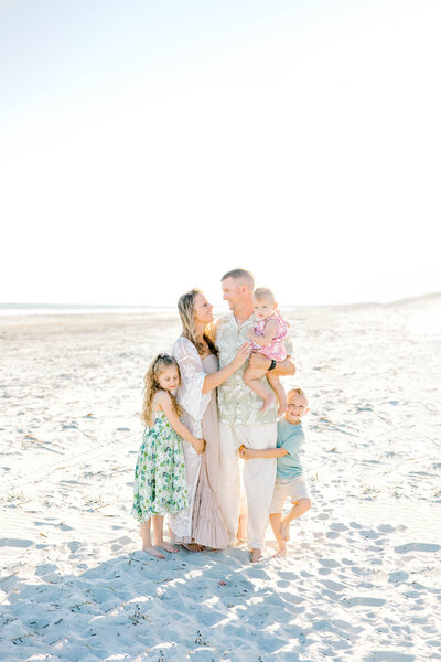 Family dnuggles together on Isle of Palms for family pictures