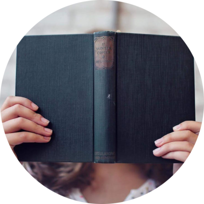 lady holding book over face