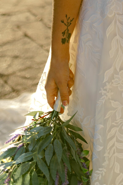 A bride holding her lavender filled wedding bouquet during her Louisiana bridal portraits. 