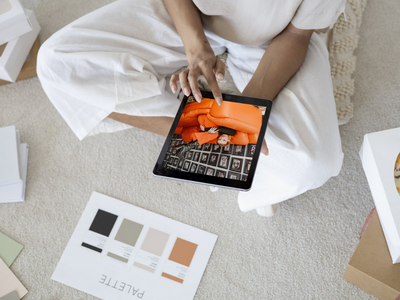 Woman on an ipad with color swatches showing a blog post about how to choose the perfect website template for your brand without the stress.