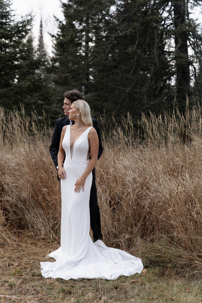 Quiet moment as an eloping couple gazes at the breathtaking scenery around them captured by an adventure wedding photographer.