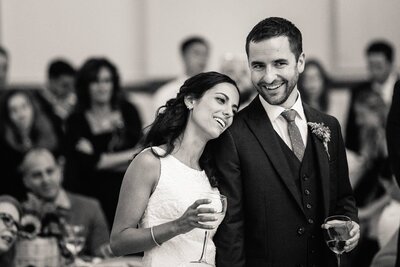 a bride lays her head on her grooms shoulder. 