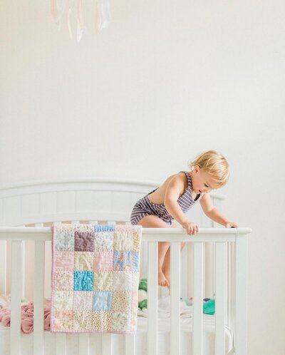 baby jumping in crib from photographing children beginner course