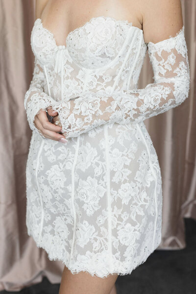 black and white image bride wearing strapless satin wedding dress with long train