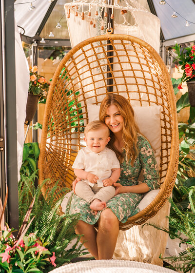 Mother and son playing in a boho greenhouse