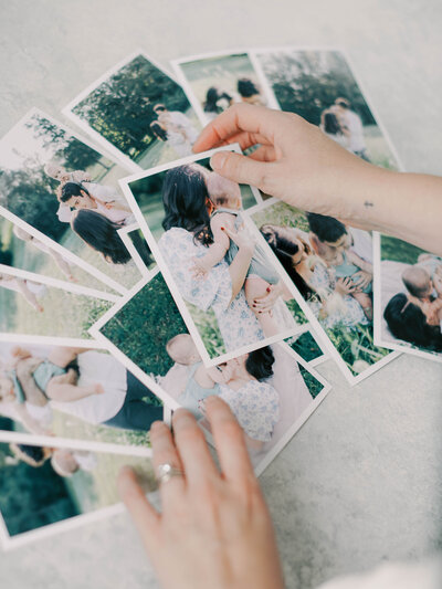 hands holding printed images by richmond family photographer