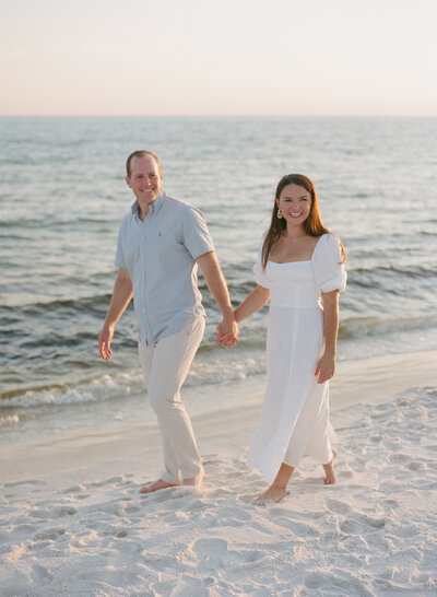 Man in a button down jacket adjusting a western style hat on his head