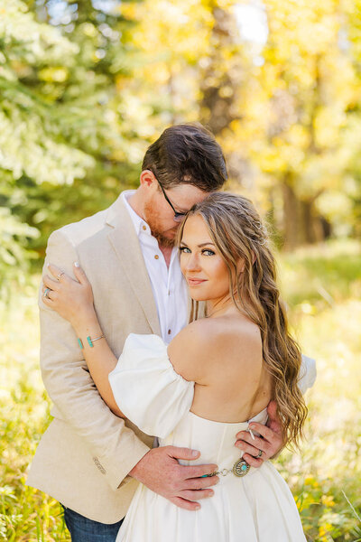 Bride and groom portrait on their elopement day in Jackson, Wyoming, surrounded by vibrant autumn foliage, capturing the essence of love and adventure in a breathtaking natural setting.
